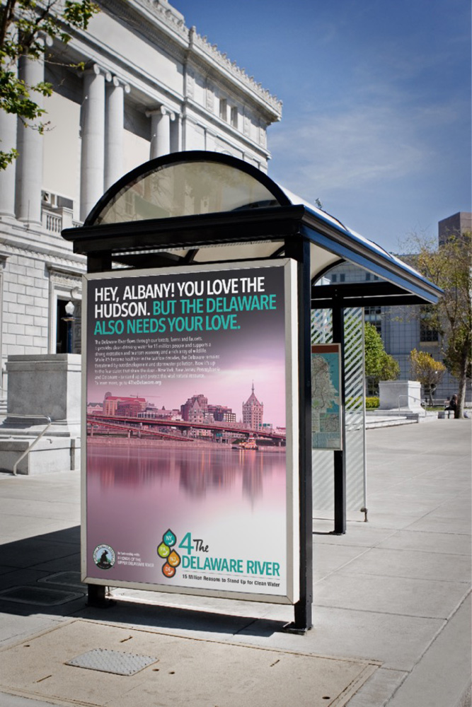 A bus stop with a poster advertising the delaware river.